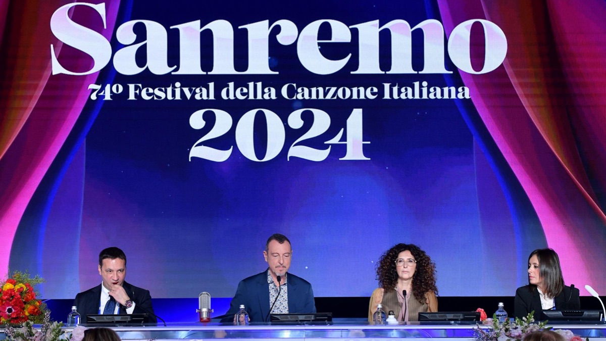 Amadeus in conferenza stampa: gag "rovinata" dalle "espressioni" di John Travolta